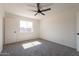 Light-filled bedroom features a ceiling fan and a large window at 3118 S Los Altos Dr, Mesa, AZ 85202
