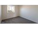 Bedroom featuring neutral walls, plush carpet, and a window providing natural light at 3118 S Los Altos Dr, Mesa, AZ 85202