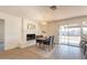Bright dining area boasts a fireplace, modern light, and seamless access to outdoor living through sliding doors at 3118 S Los Altos Dr, Mesa, AZ 85202