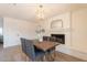 Dining room with brick fireplace, modern light fixture, and wood-look tile flooring at 3118 S Los Altos Dr, Mesa, AZ 85202