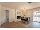 Bright dining room featuring a white brick fireplace, stylish light fixture, and sliding glass doors to the backyard at 3118 S Los Altos Dr, Mesa, AZ 85202