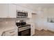 Close-up of kitchen with white cabinets, quartz countertops, and stainless steel appliances at 3118 S Los Altos Dr, Mesa, AZ 85202