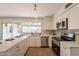 Bright kitchen featuring white cabinets, quartz countertops, and stainless steel appliances at 3118 S Los Altos Dr, Mesa, AZ 85202