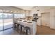 Contemporary kitchen features white cabinets, stainless steel appliances, and counter seating overlooking backyard at 3118 S Los Altos Dr, Mesa, AZ 85202