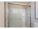 Modern shower features marble tile, a frosted glass door, and shelving at 3118 S Los Altos Dr, Mesa, AZ 85202