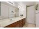 Bathroom features a double sink vanity with decorative wreath and white doors at 3330 S Gilbert Rd # 2090, Chandler, AZ 85286