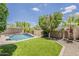 Beautiful backyard featuring a pool and lush landscaping at 3422 E Strawberry Dr, Gilbert, AZ 85298