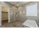 En suite bathroom featuring an oversized glass shower, soaking tub, and a walk-in closet at 3422 E Strawberry Dr, Gilbert, AZ 85298