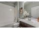 Bathroom featuring a white shower-tub combo, a sleek vanity, and neutral-toned decor for a calming atmosphere at 3422 E Strawberry Dr, Gilbert, AZ 85298