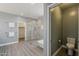 En suite bathroom featuring an oversized glass shower, soaking tub, and a walk-in closet at 3422 E Strawberry Dr, Gilbert, AZ 85298