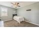 Cozy bedroom featuring a ceiling fan, plush carpeting, a comfortable bed, and soft, neutral tones for relaxation at 3422 E Strawberry Dr, Gilbert, AZ 85298