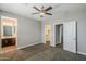 Spacious bedroom with a ceiling fan, carpet, and access to both a walk-in closet and ensuite bathroom at 3422 E Strawberry Dr, Gilbert, AZ 85298
