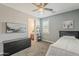Stylish bedroom with a ceiling fan, comfy bed, modern dresser, and access to an ensuite bathroom for added convenience at 3422 E Strawberry Dr, Gilbert, AZ 85298
