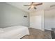 Serene bedroom featuring a ceiling fan, carpeted floors, and a closet, offering a cozy retreat within the home at 3422 E Strawberry Dr, Gilbert, AZ 85298