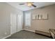 Bedroom featuring neutral walls, a ceiling fan, window shutters, and a closet with sliding doors at 3422 E Strawberry Dr, Gilbert, AZ 85298