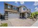 Two-story home boasting brick driveway, two-car garage, and well-manicured landscaping, complemented by warm exterior colors at 3422 E Strawberry Dr, Gilbert, AZ 85298