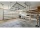 Garage featuring an insulated door, storage shelves and a drop-down rack at 3422 E Strawberry Dr, Gilbert, AZ 85298