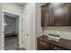 Hallway with dark wood cabinets, offering ample storage and a modern, streamlined look at 3422 E Strawberry Dr, Gilbert, AZ 85298