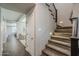 Hallway features a carpeted staircase with wrought iron and wood detail and wood-look floors at 3422 E Strawberry Dr, Gilbert, AZ 85298
