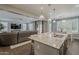 Open-concept kitchen flowing into the living room, featuring an island and modern finishes for seamless entertaining at 3422 E Strawberry Dr, Gilbert, AZ 85298