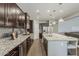 Spacious kitchen features granite countertops, stainless steel appliances, and a large center island at 3422 E Strawberry Dr, Gilbert, AZ 85298
