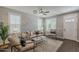 Bright living room features wood-look floors, neutral furnishings, plantation shutters, and a ceiling fan for added comfort at 3422 E Strawberry Dr, Gilbert, AZ 85298