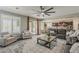 Comfortable living room with neutral tones, ceiling fan, and abundant natural light from the backyard patio at 3422 E Strawberry Dr, Gilbert, AZ 85298