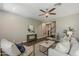 Inviting living room showcases wood-look floors, neutral furniture, plantation shutters, and an open layout to the staircase at 3422 E Strawberry Dr, Gilbert, AZ 85298