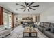 Inviting living room with a large sectional sofa and view into the kitchen area creating a seamless flow at 3422 E Strawberry Dr, Gilbert, AZ 85298