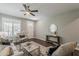 Cozy living room with wood-look floors, neutral decor, plantation shutters, and a ceiling fan for a relaxing atmosphere at 3422 E Strawberry Dr, Gilbert, AZ 85298