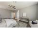 Bright bedroom with ensuite bathroom featuring a ceiling fan, decor and a modern vanity at 3422 E Strawberry Dr, Gilbert, AZ 85298