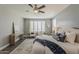 Bright bedroom with a ceiling fan, plantation shutters, decor and a modern vanity at 3422 E Strawberry Dr, Gilbert, AZ 85298