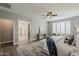 Bright bedroom with ensuite bathroom featuring a ceiling fan, plantation shutters, decor and a modern vanity at 3422 E Strawberry Dr, Gilbert, AZ 85298