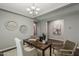 Well-lit office featuring a cozy rug, a wooden desk adorned with a plant and decor and comfortable seating at 3422 E Strawberry Dr, Gilbert, AZ 85298