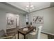 Bright office space with neutral walls and a wooden desk, complemented by a stylish chandelier and modern decor at 3422 E Strawberry Dr, Gilbert, AZ 85298
