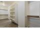 Spacious walk-in closet featuring custom shelving, vinyl flooring, and a convenient layout for optimal organization at 3422 E Strawberry Dr, Gilbert, AZ 85298