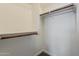 Spacious walk-in closet featuring wood rods and shelving at 3422 E Strawberry Dr, Gilbert, AZ 85298