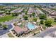 Aerial view of community pool, clubhouse, green spaces, and surrounding neighborhood at 3458 E Ivanhoe St, Gilbert, AZ 85295
