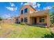 A lush backyard view highlighting the home's tan stucco exterior at 3458 E Ivanhoe St, Gilbert, AZ 85295