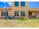 Tan home's backyard with a patio, green grass and two a/c units at 3458 E Ivanhoe St, Gilbert, AZ 85295