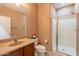 Bathroom featuring a glass door shower, toilet, vanity and mirror at 3458 E Ivanhoe St, Gilbert, AZ 85295