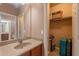 Bathroom with sink vanity and view into a walk-in closet at 3458 E Ivanhoe St, Gilbert, AZ 85295