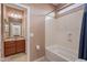 Bathroom with tub, shower, and vanity with dark wood cabinets at 3458 E Ivanhoe St, Gilbert, AZ 85295