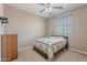 Cozy bedroom with ceiling fan, closet, and natural light from the window at 3458 E Ivanhoe St, Gilbert, AZ 85295