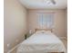 Bright bedroom with a large window and ceiling fan and a bed with a floral comforter at 3458 E Ivanhoe St, Gilbert, AZ 85295