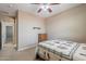 Neutral bedroom with ceiling fan, closet, and views into another room at 3458 E Ivanhoe St, Gilbert, AZ 85295