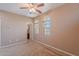 A carpeted bedroom provides a comfortable space, ceiling fan and easy access to the ensuite bath at 3458 E Ivanhoe St, Gilbert, AZ 85295