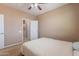 Neutral bedroom with a ceiling fan, carpet flooring, and ensuite bathroom at 3458 E Ivanhoe St, Gilbert, AZ 85295