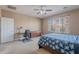 Bedroom with a large window, ceiling fan, and plenty of space for a bed and desk at 3458 E Ivanhoe St, Gilbert, AZ 85295