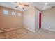 The carpeted bedroom includes a ceiling fan, natural light from windows, and a closet at 3458 E Ivanhoe St, Gilbert, AZ 85295